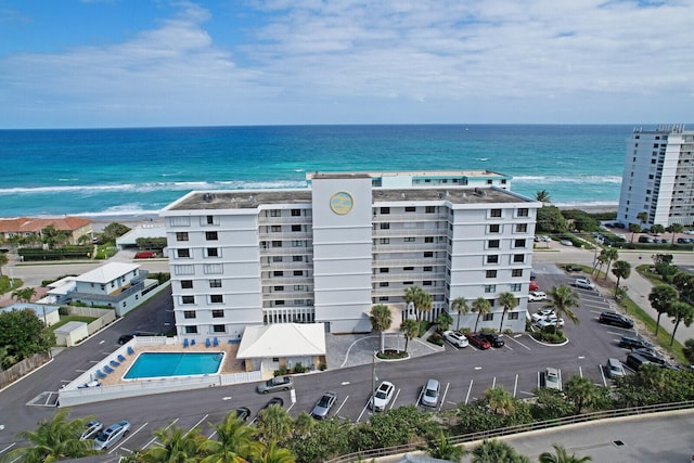 birds eye view of property featuring a beach view and a water view