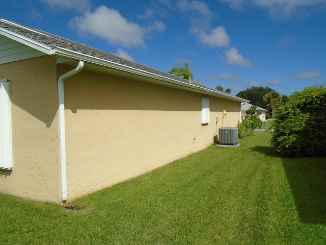 view of home's exterior featuring a yard and central AC unit