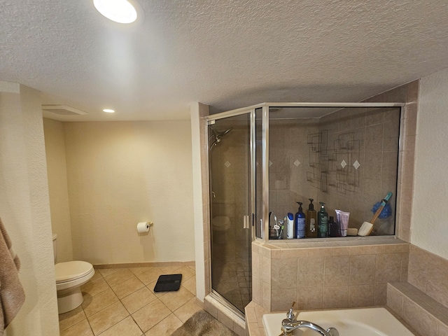 bathroom featuring toilet, shower with separate bathtub, tile patterned floors, and a textured ceiling