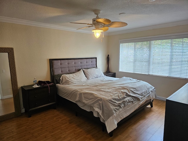 bedroom featuring a textured ceiling, crown molding, ceiling fan, and dark hardwood / wood-style flooring