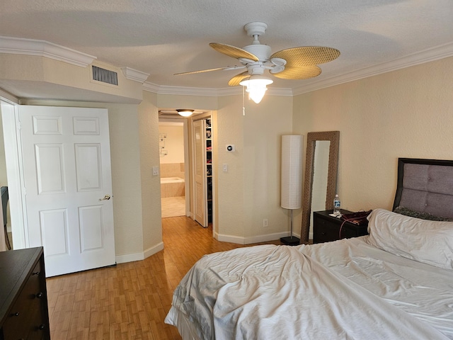 bedroom featuring ceiling fan, ornamental molding, a textured ceiling, and light hardwood / wood-style flooring