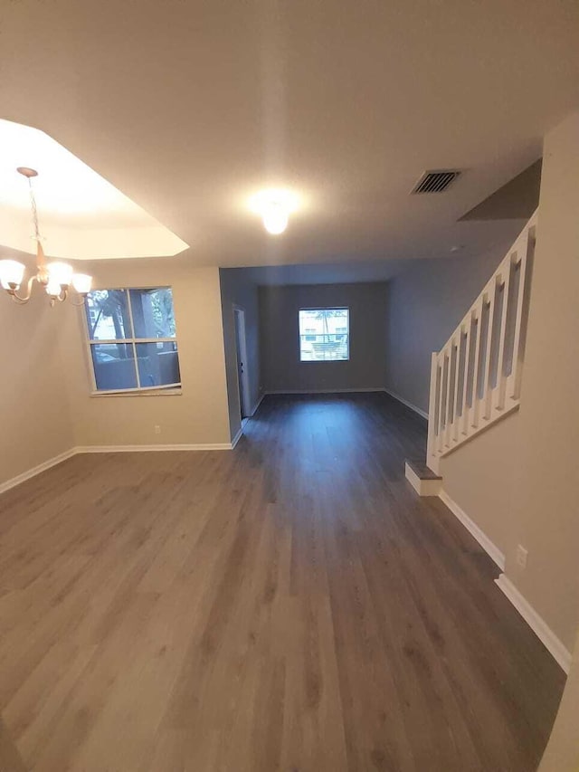 foyer featuring dark wood-type flooring and a notable chandelier