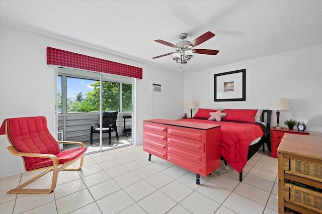 tiled bedroom with a wall mounted air conditioner, a textured ceiling, and ceiling fan