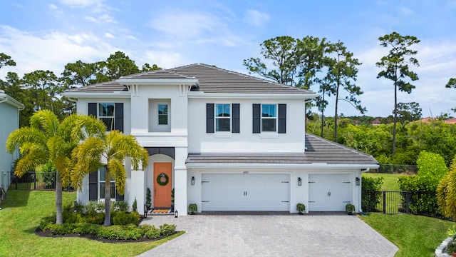 view of front of property with a garage and a front lawn