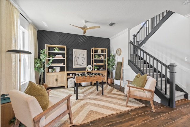 interior space with a healthy amount of sunlight, ceiling fan, and dark hardwood / wood-style flooring