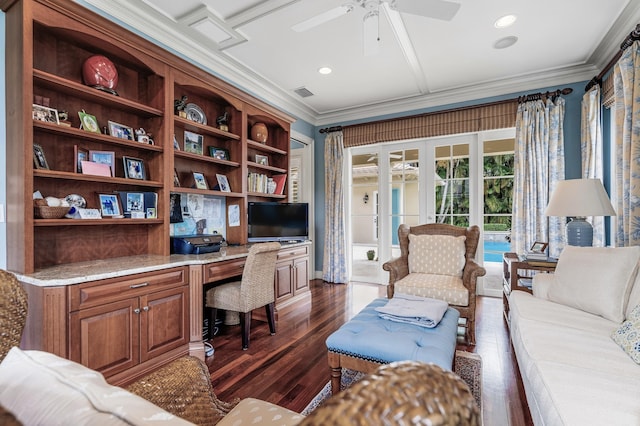 office featuring dark wood-style floors, visible vents, ceiling fan, built in desk, and crown molding