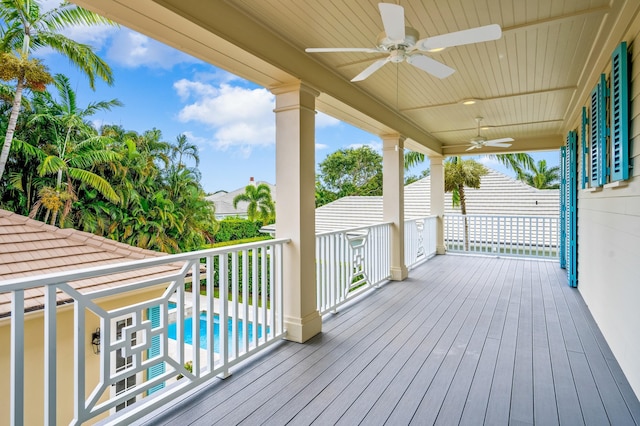 deck featuring an outdoor pool and ceiling fan