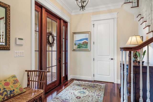 foyer entrance with crown molding, french doors, and dark hardwood / wood-style flooring