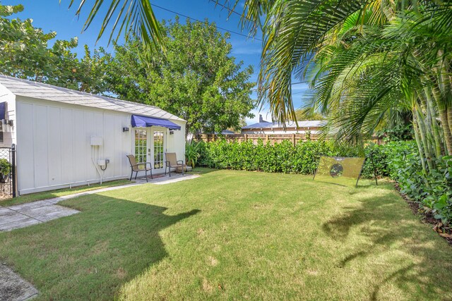 view of yard with french doors and a patio