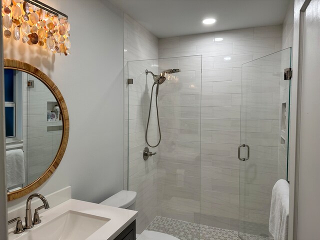 bathroom featuring vanity, toilet, and an enclosed shower