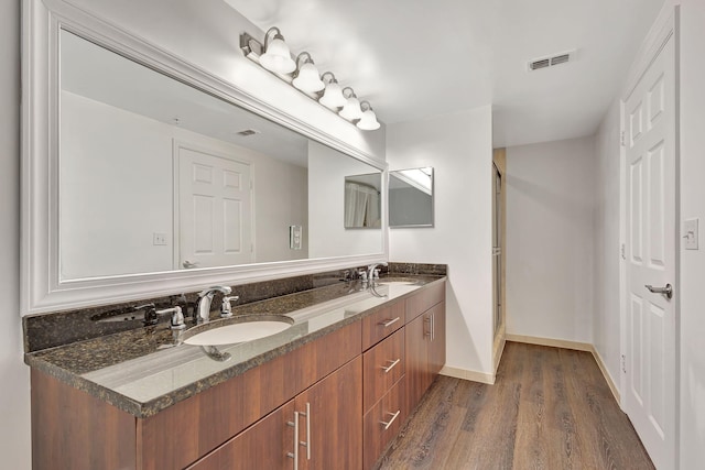 bathroom featuring vanity and hardwood / wood-style floors