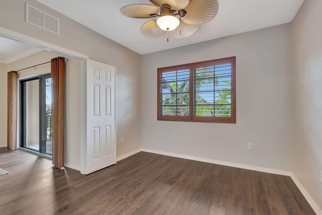 empty room with ceiling fan and dark hardwood / wood-style flooring