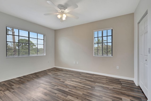 unfurnished bedroom with dark wood-type flooring, ceiling fan, and a closet