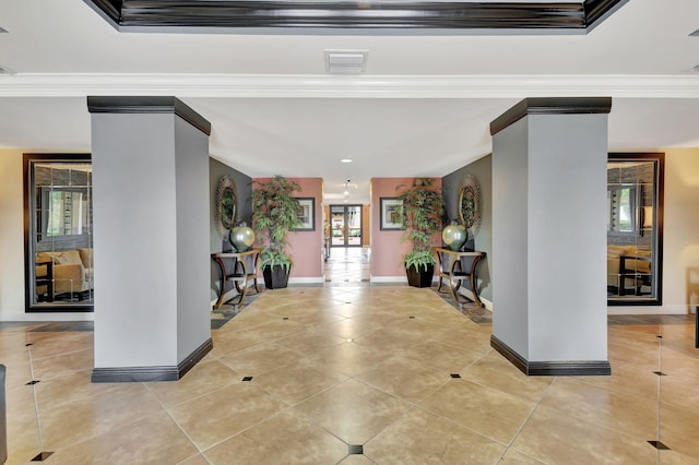 tiled foyer entrance featuring a wealth of natural light and ornamental molding