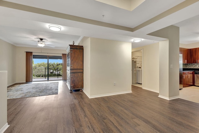 interior space featuring ornamental molding, wood-type flooring, ceiling fan, and washer / clothes dryer