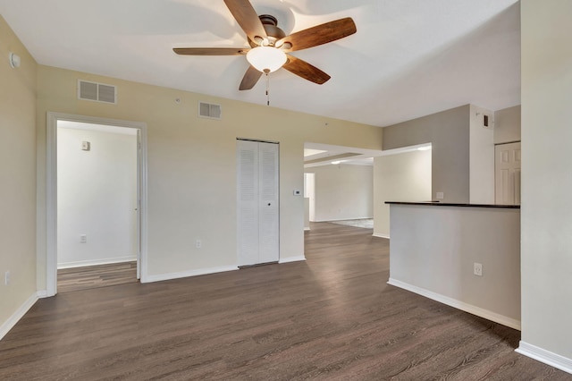 spare room with dark hardwood / wood-style flooring and ceiling fan