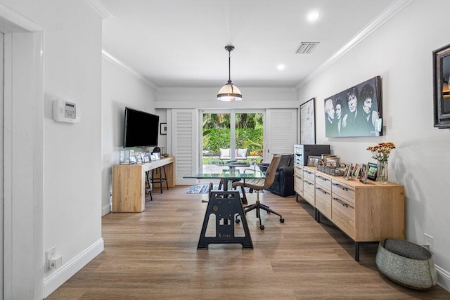 dining room featuring ornamental molding and hardwood / wood-style floors