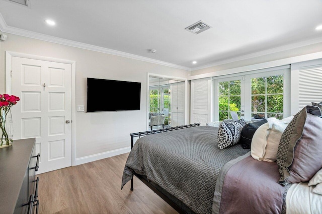 bedroom featuring ornamental molding, french doors, and light hardwood / wood-style flooring