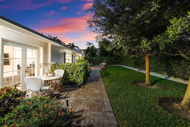 yard at dusk with a patio