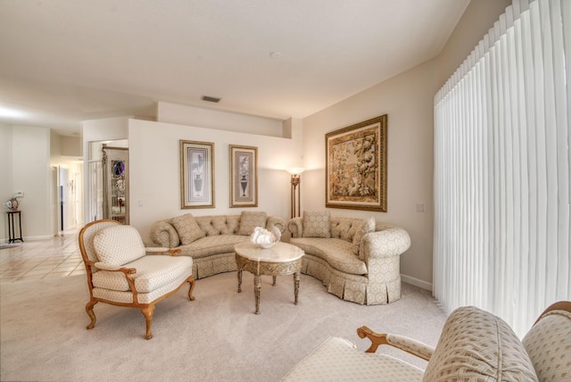 living room featuring light carpet, visible vents, and baseboards