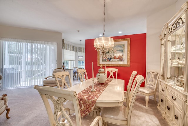 dining space with a chandelier, recessed lighting, and light colored carpet