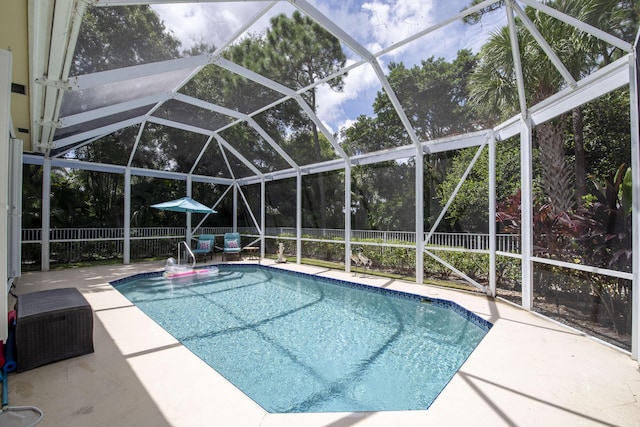 view of pool featuring a fenced backyard, a patio area, and a lanai