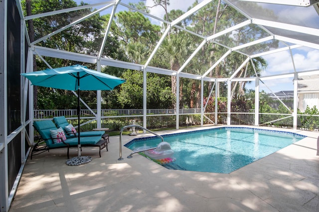 view of pool with a fenced in pool, a patio area, glass enclosure, and a fenced backyard