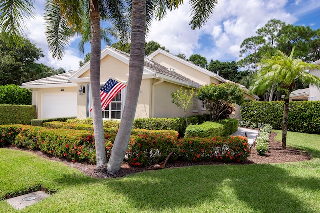 view of property exterior featuring a yard, an attached garage, and stucco siding