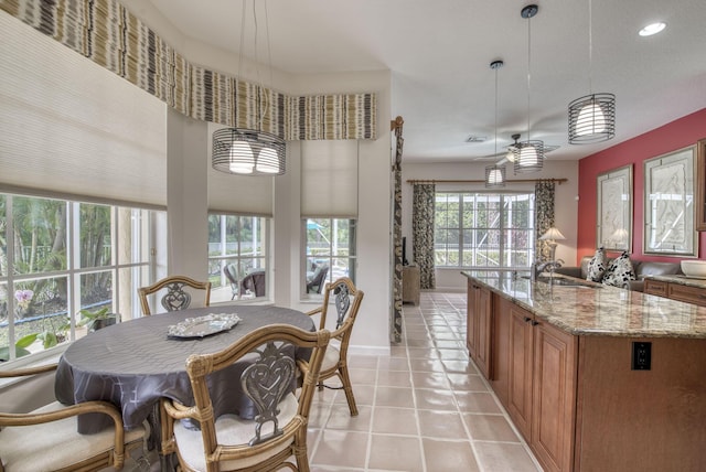 dining room with light tile patterned floors and ceiling fan