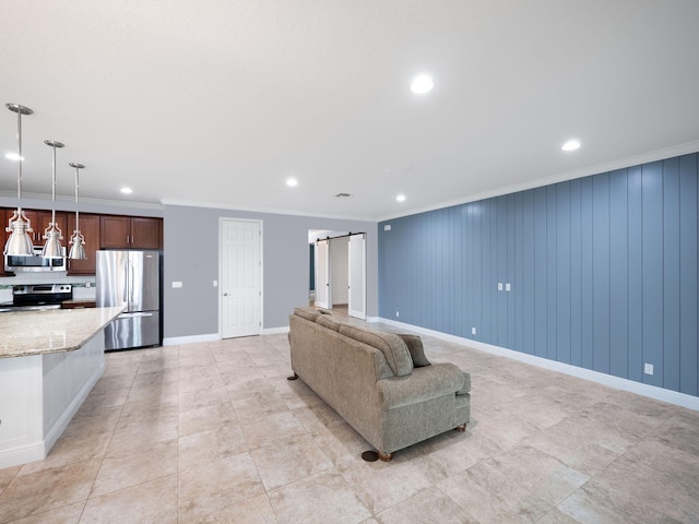 unfurnished living room featuring a barn door and ornamental molding