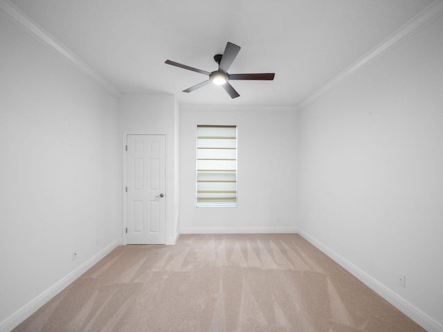 carpeted spare room with crown molding and ceiling fan