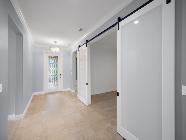 hallway featuring a barn door, light tile patterned floors, and ornamental molding