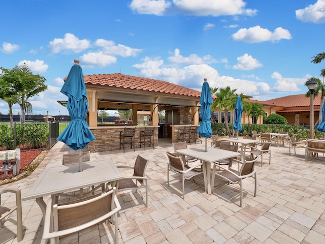 view of patio / terrace featuring an outdoor bar