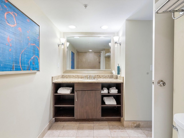 bathroom with vanity, toilet, a shower with door, and tile patterned floors