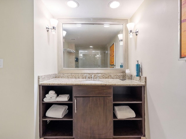 bathroom featuring walk in shower and vanity