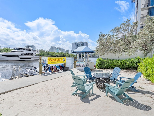 view of patio / terrace featuring a water view and a fire pit