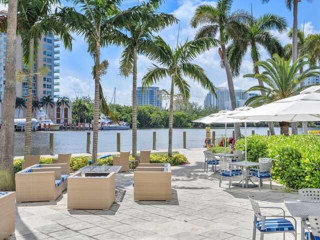 view of patio with a water view and an outdoor fire pit