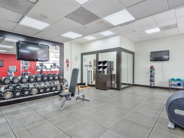 exercise room with a paneled ceiling