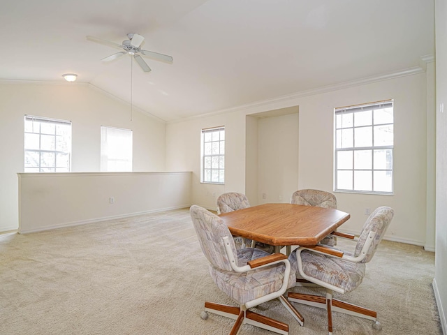 carpeted dining space featuring crown molding, plenty of natural light, ceiling fan, and vaulted ceiling