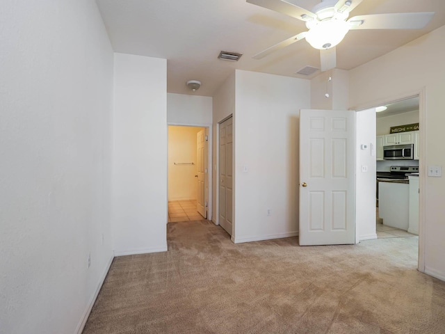 carpeted spare room with ceiling fan