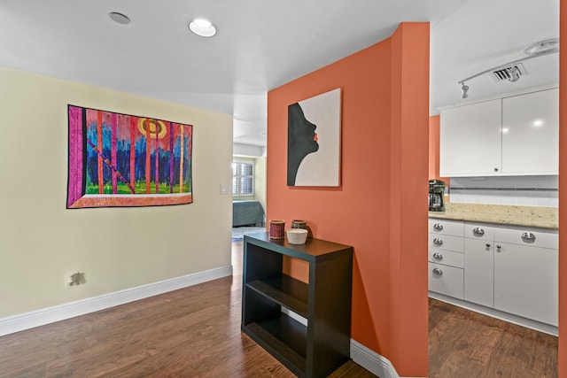 hallway with dark hardwood / wood-style flooring