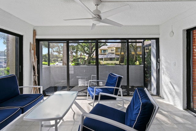 sunroom / solarium featuring ceiling fan