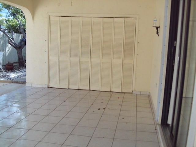 exterior space with a closet and light tile patterned floors