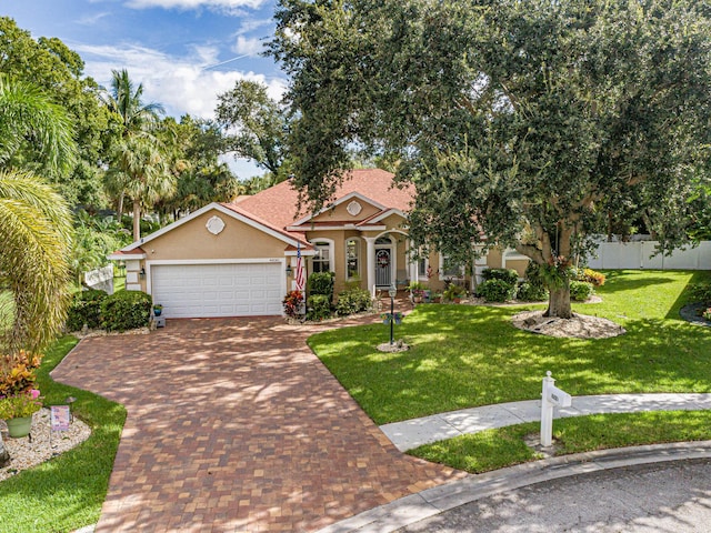 view of front of house featuring a front yard and a garage