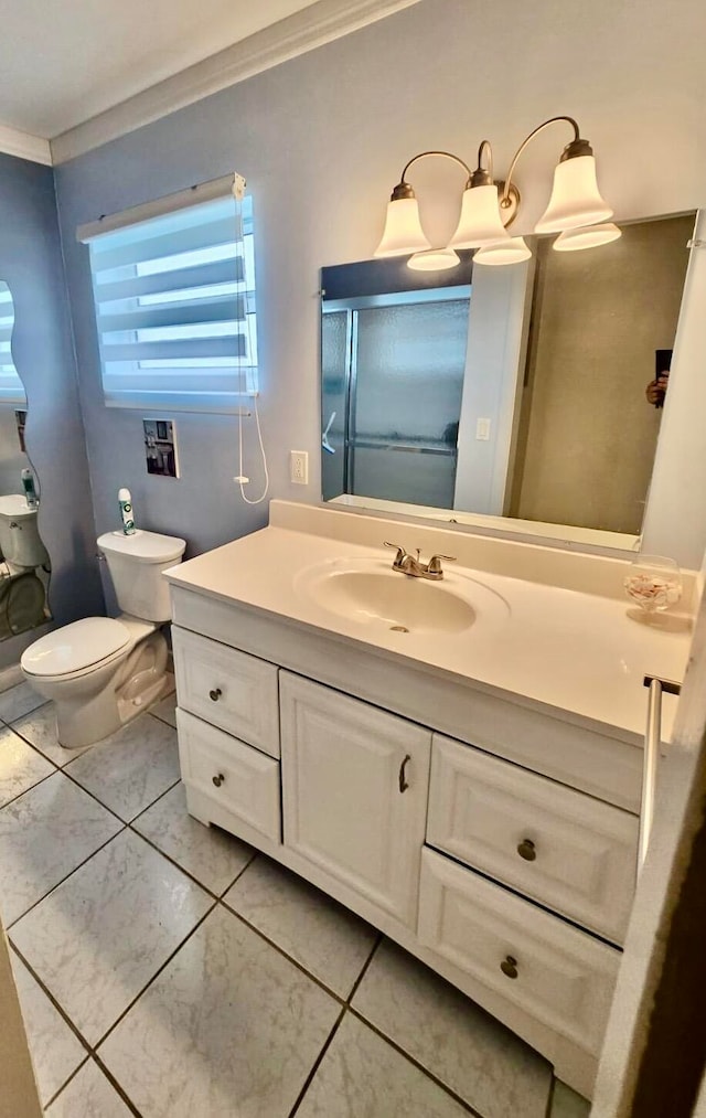 bathroom with crown molding, vanity, toilet, and tile patterned floors