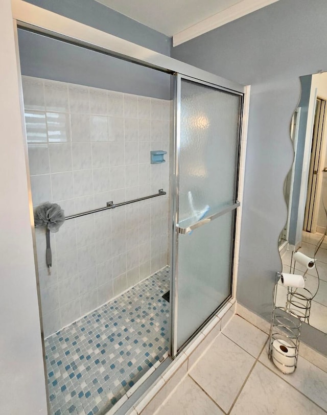 bathroom with tile patterned flooring and a shower with shower door