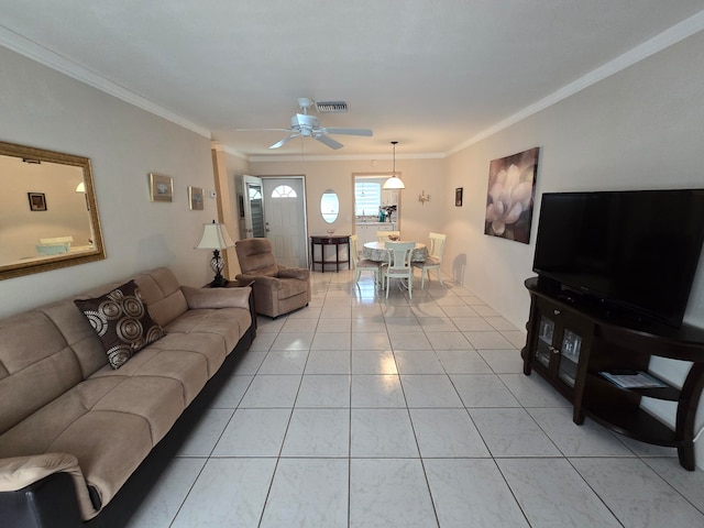 living room with ornamental molding, light tile patterned floors, and ceiling fan