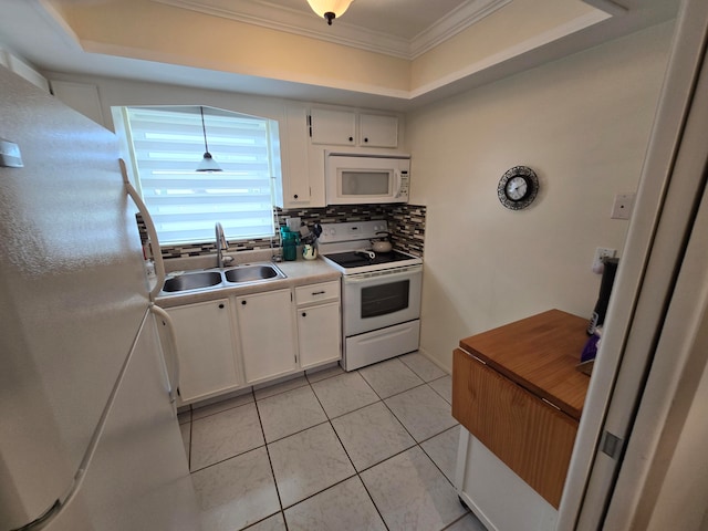 kitchen featuring white cabinetry, white appliances, a tray ceiling, and sink