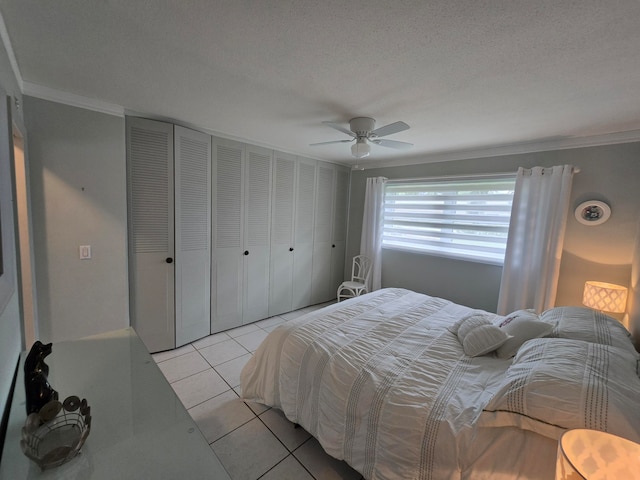 bedroom with crown molding, a textured ceiling, light tile patterned floors, and ceiling fan