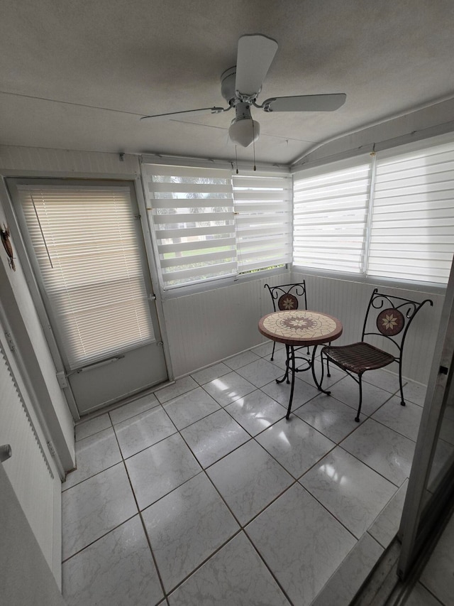 interior space with ceiling fan